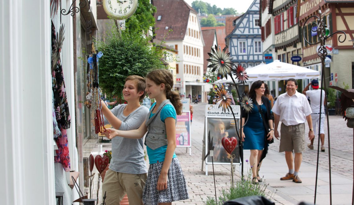 A shopping street is bustling with activity