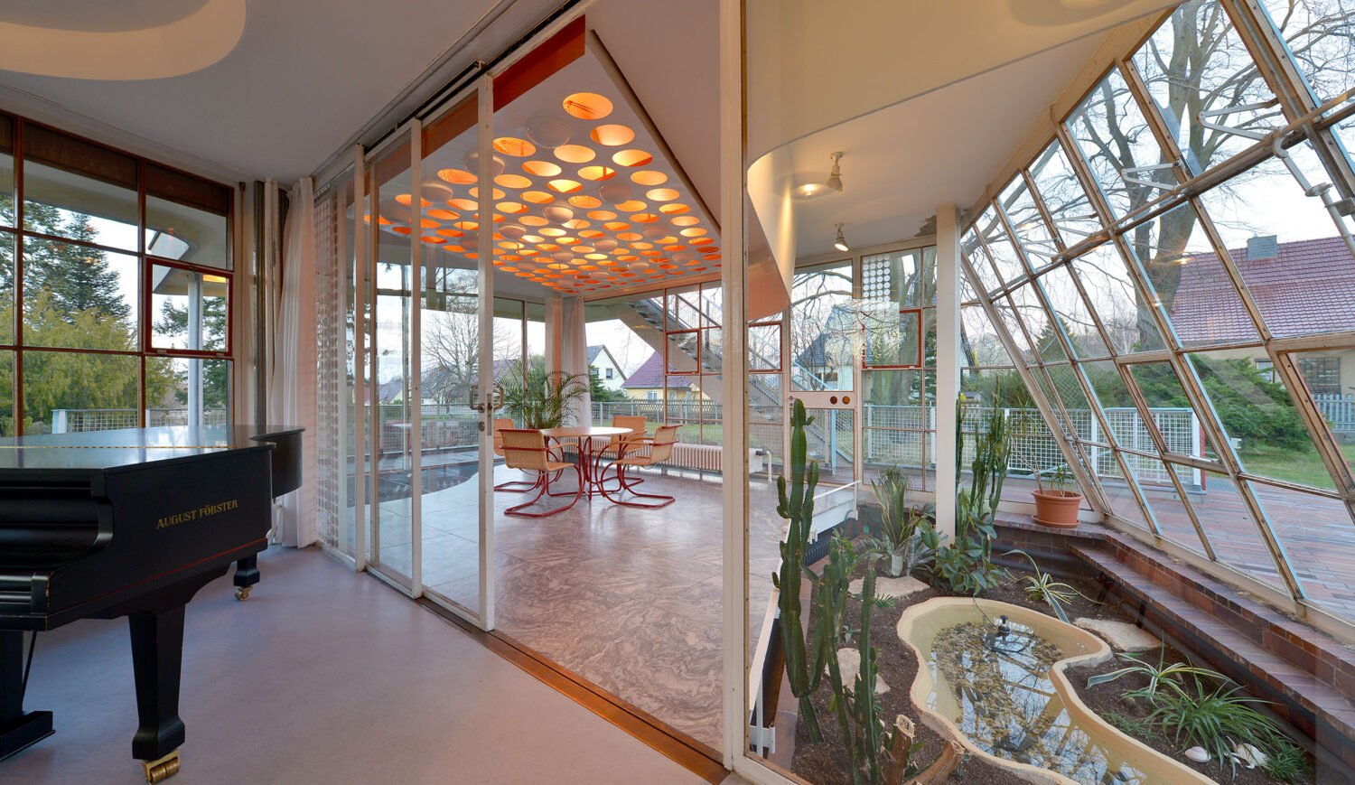 The elongated living room on the first floor opens to the east into a winter garden
