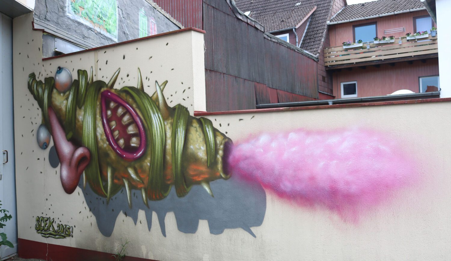 Wer steckt hinter Street Artist*in Skec? Er, sie, es lebt in Hamburg – und knallt furchterregend amüsante Phantasiefiguren an Häuserfassaden, die man so schnell nicht wieder vergisst. Diese hier verblüfft seit 2015 in Einbeck